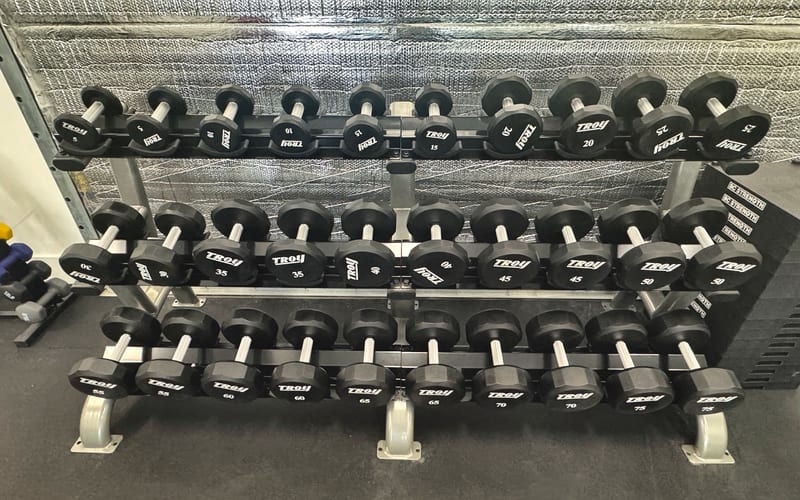 Rows of dumbbells on the strength floor at Solstice.